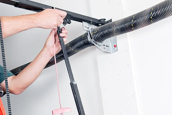 expert replacing garage door spring
