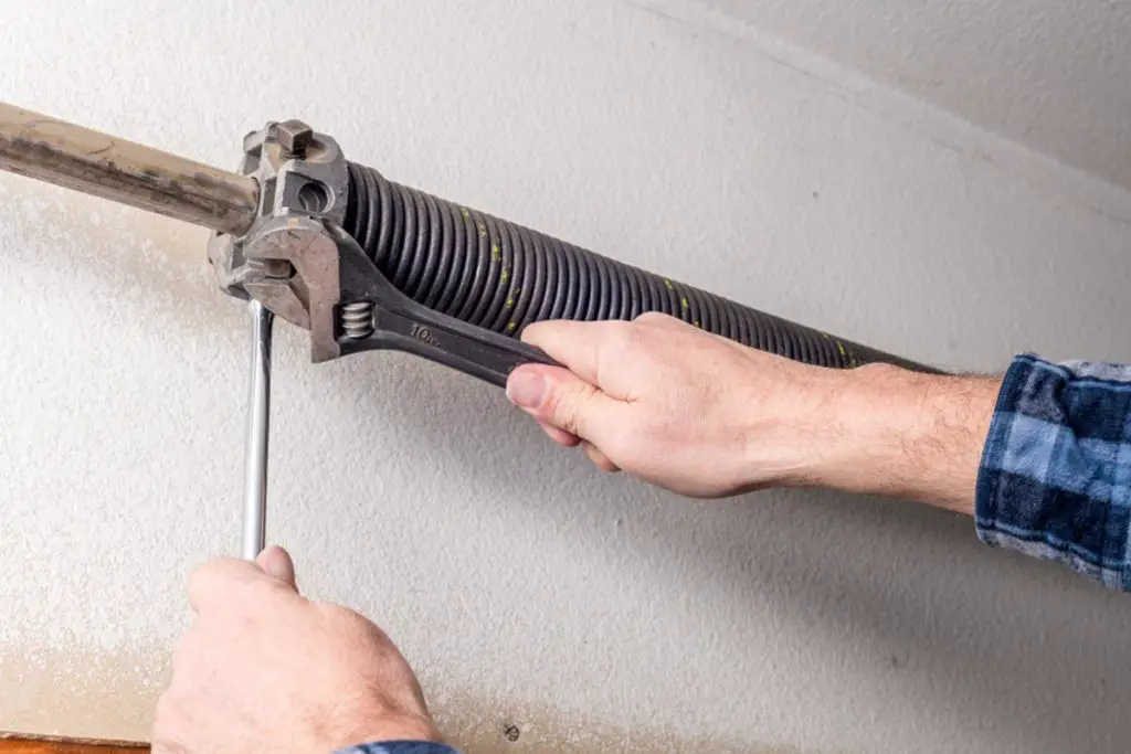 man tightening screws
